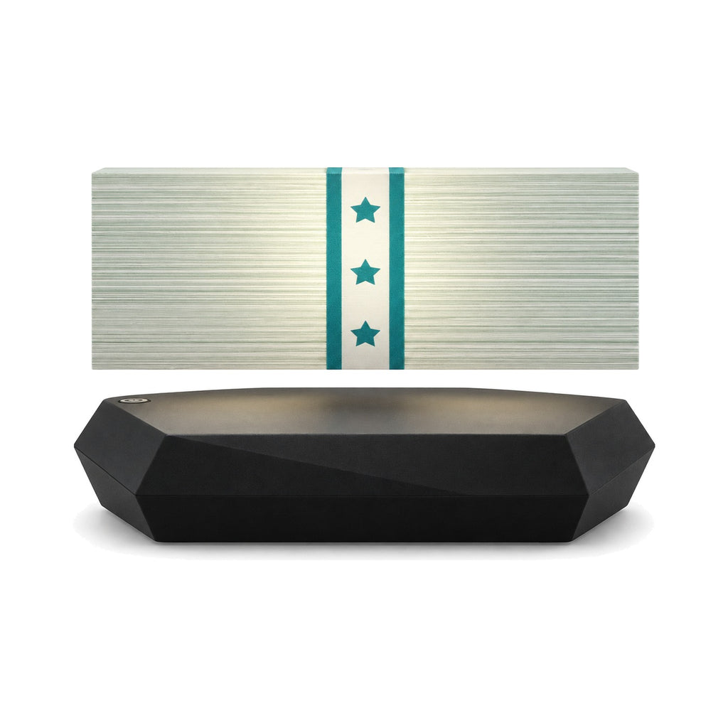 Banknote stack lamp levitating above its black hexagonal base, front view