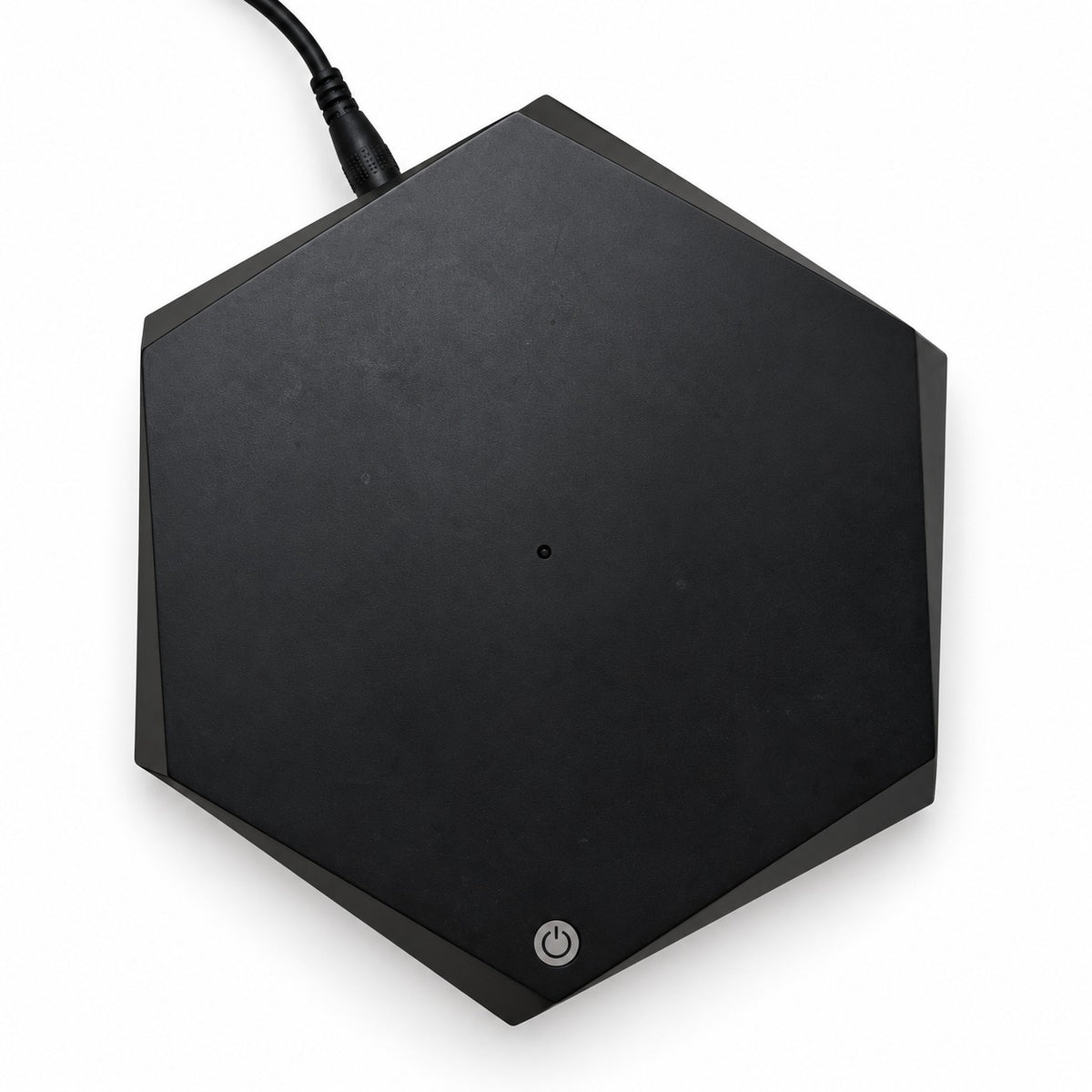 Black hexagonal base seen from above, power button and plugged-in cable